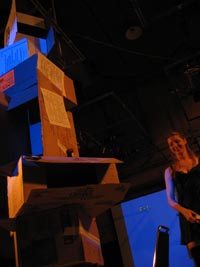 Girl in black dress
    presenting box stack